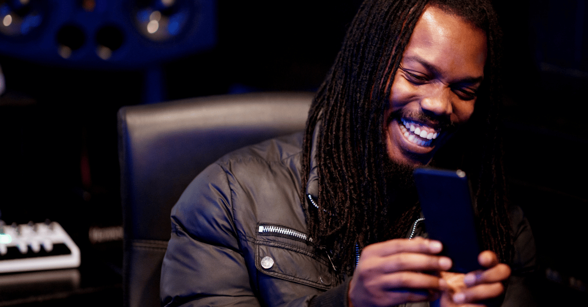 african american male laugh using smartphone