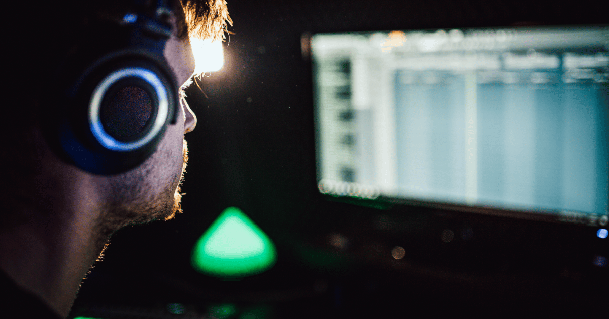 young male wearing headset working on his sound effects for a film